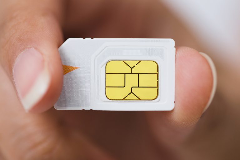 Hand holding sim card, select focus